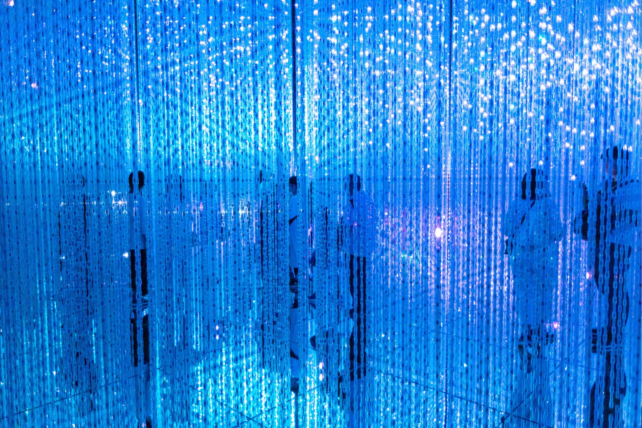 Humans seen through illuminated lighting equipment. Looking futuristic and abstract.