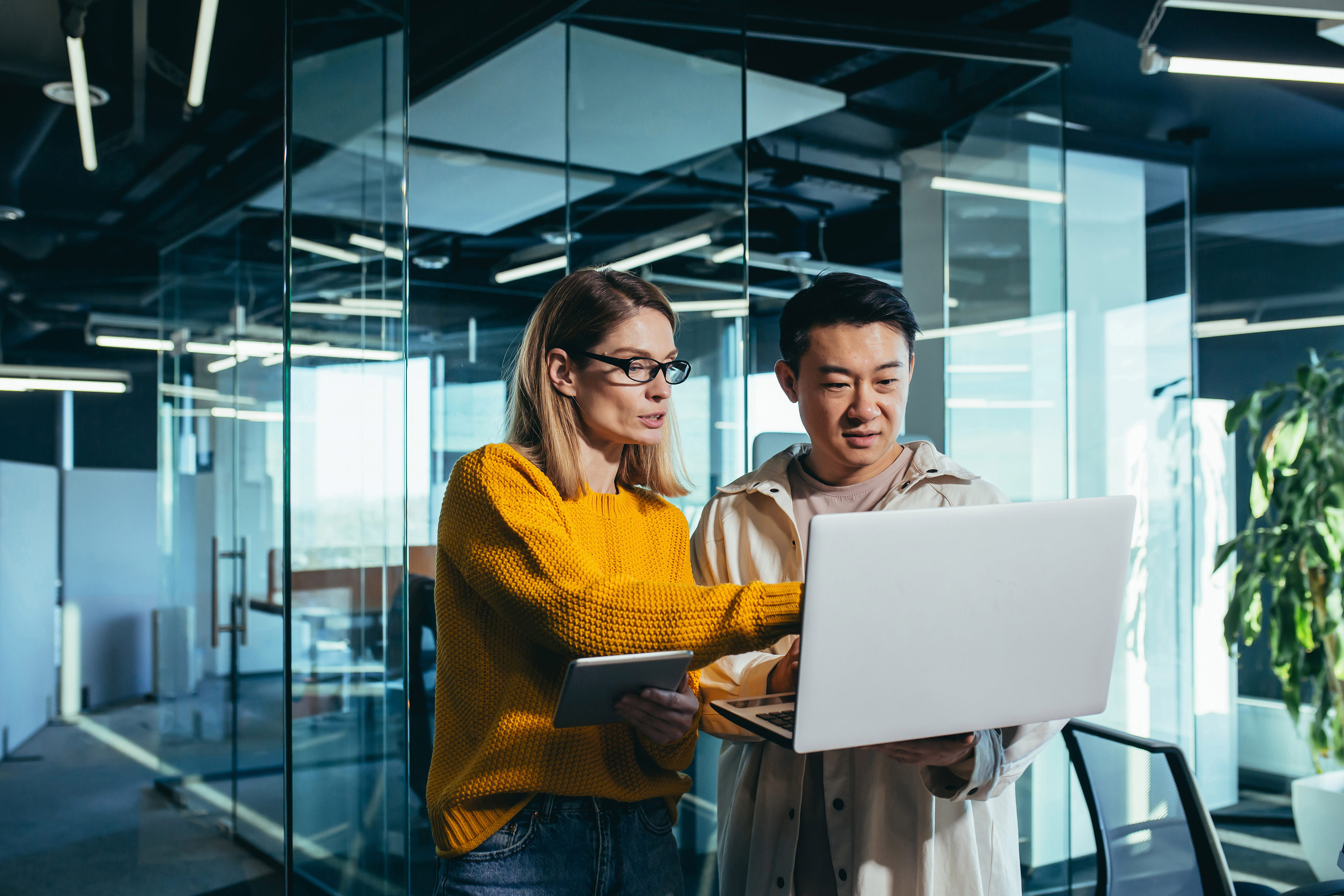 Business colleagues looking at laptop