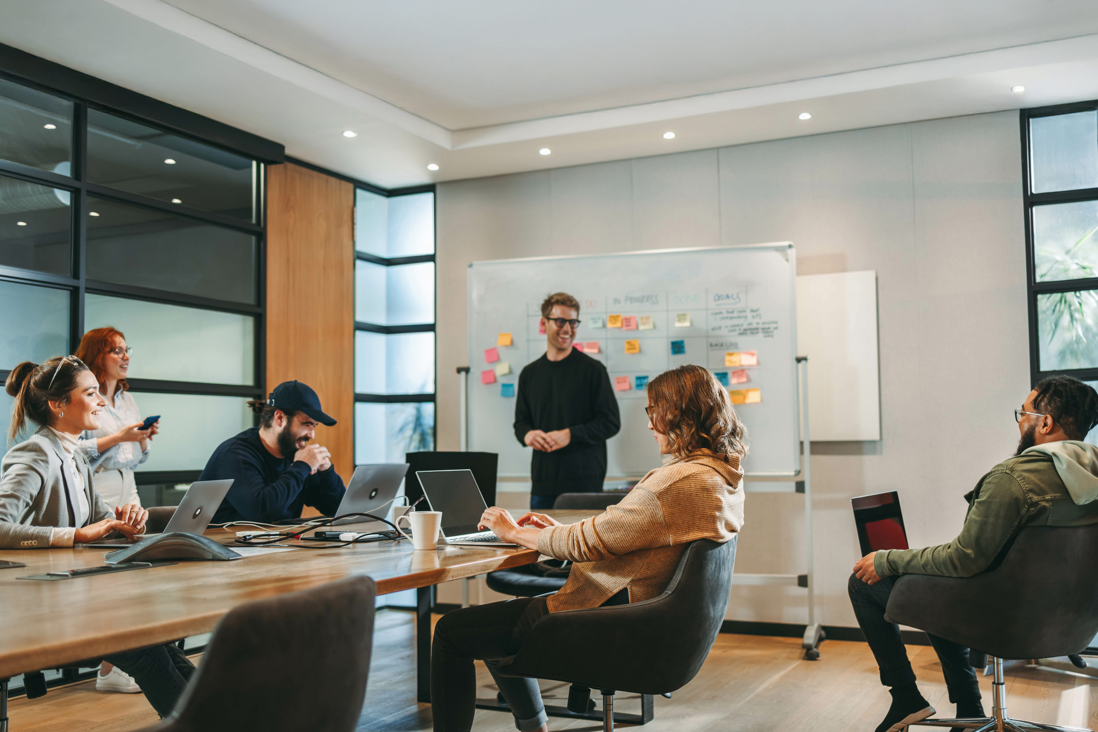 Professionals in a diverse group collaborate in a boardroom